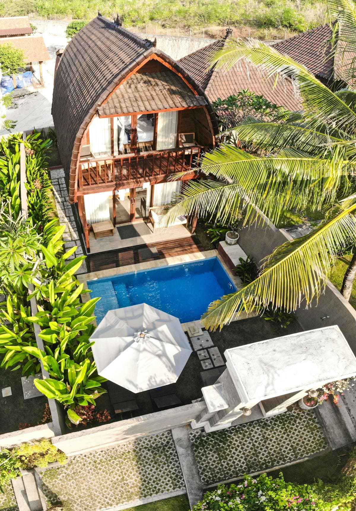 Tropical villa with private swimming pool surrounded by lush gardens in Bali